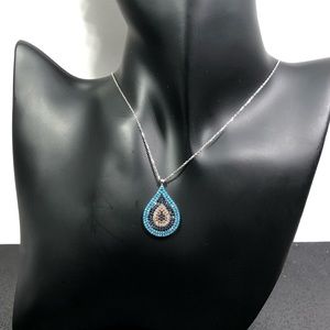 Teardrop necklace with silver chain.